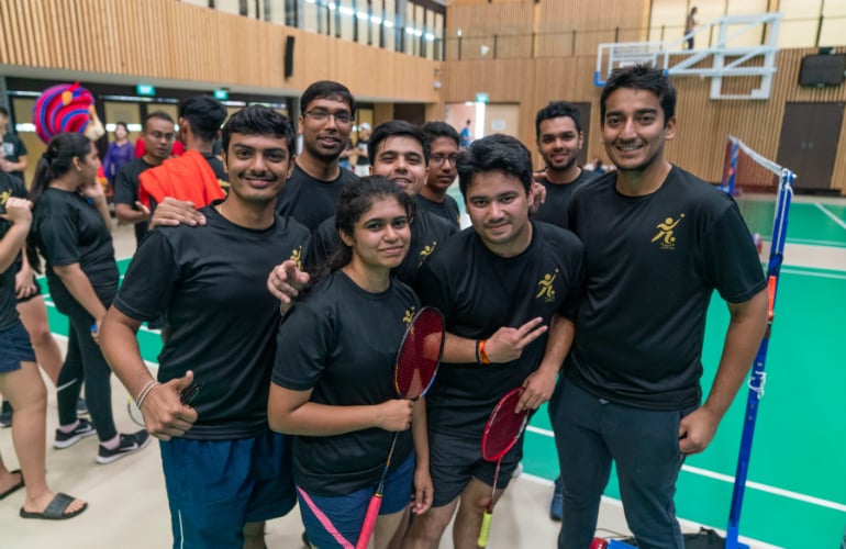 SP Jain’s badminton team players pose for a picture with their supporters